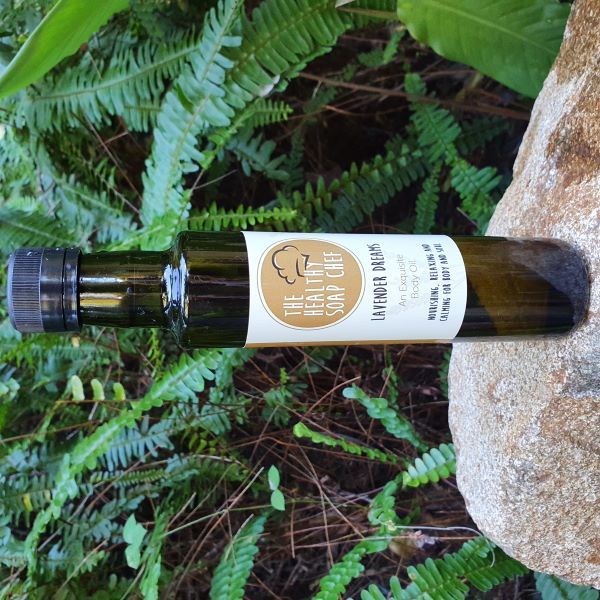 Lavender Dreams natural Body oil on Rock with ferns in background